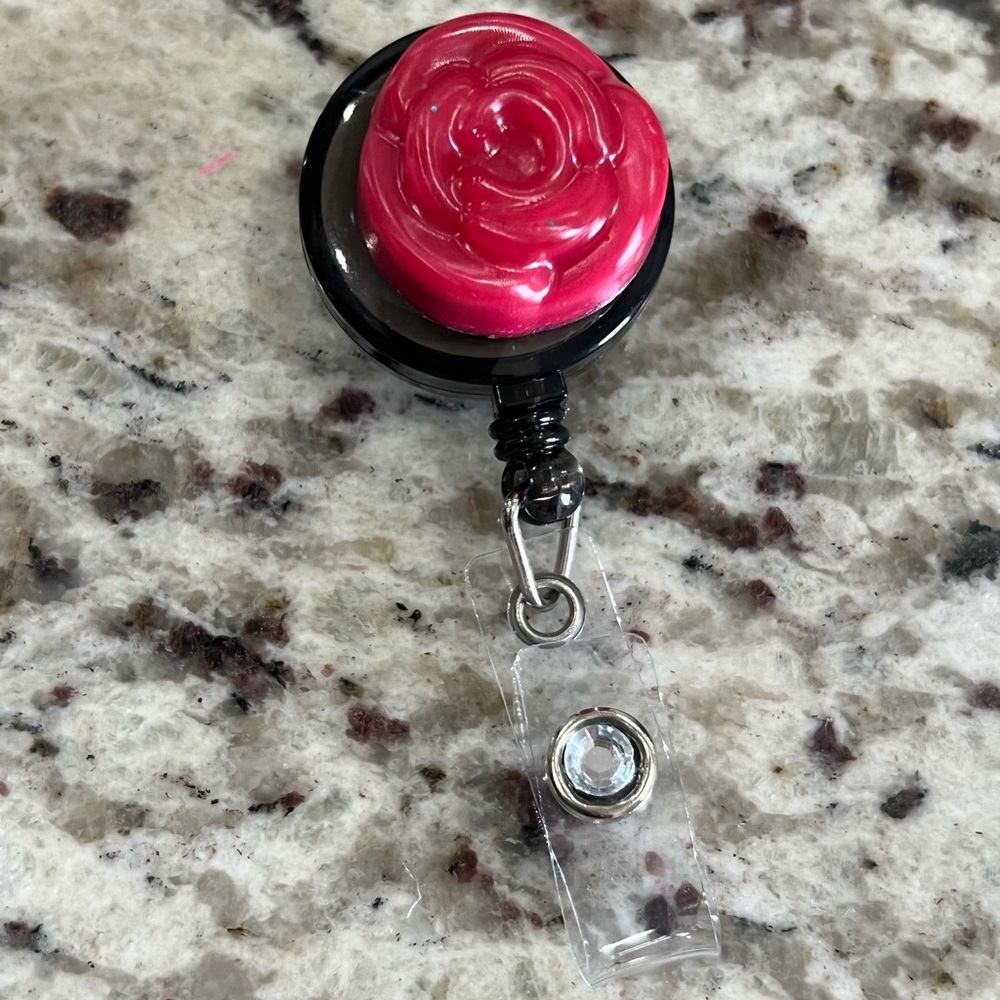 Red flower and diamond badge reel.